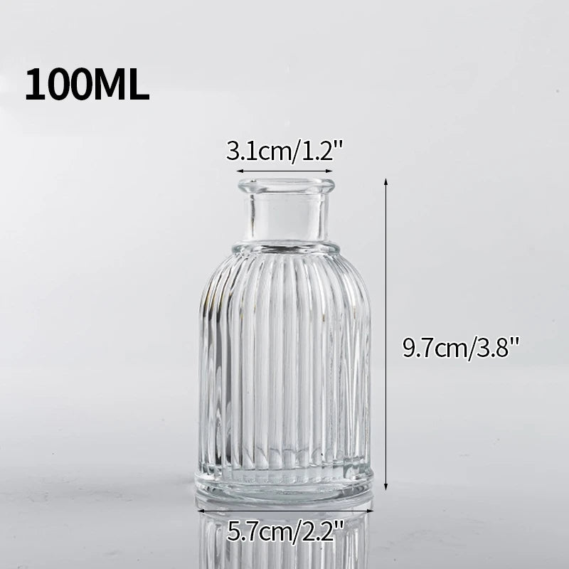 A clear glass vase with ribbed texture, measuring 9.7cm high and 5.7cm wide.