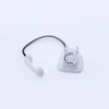 A clear plastic vintage rotary desk phone miniature with a black cord and receiver.