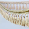 Golden beige tassel fringe trim used for decorative edging on curtains and DIY projects