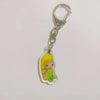 Acrylic keychain featuring a yellow banana cat character holding a green drink.