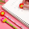 A set of cartoon animal pencils with eraser tops, including a pink pencil and a yellow pencil, resting on lined paper.