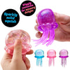 A hand holds a sparkly solid squish toy shaped like a cat paw, featuring purple and pink colors.