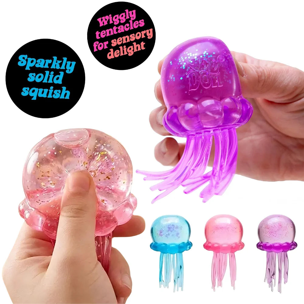 A hand holds a sparkly solid squish toy shaped like a cat paw, featuring purple and pink colors.