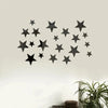 A black star wall decor set made of 3D acrylic mounted on a light-colored wall.