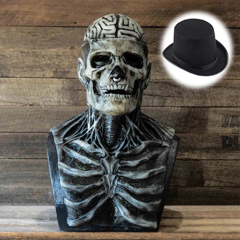 Sculpture de masque crâne réaliste avec détails faciaux et chapeau haut en noir sur fond en bois.