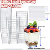 Clear square plastic dessert cups with spoons and a stack of spoons shown next to a glass cup.