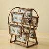 A vintage resin rotating photo frame made of wood and glass, displaying multiple framed photos.