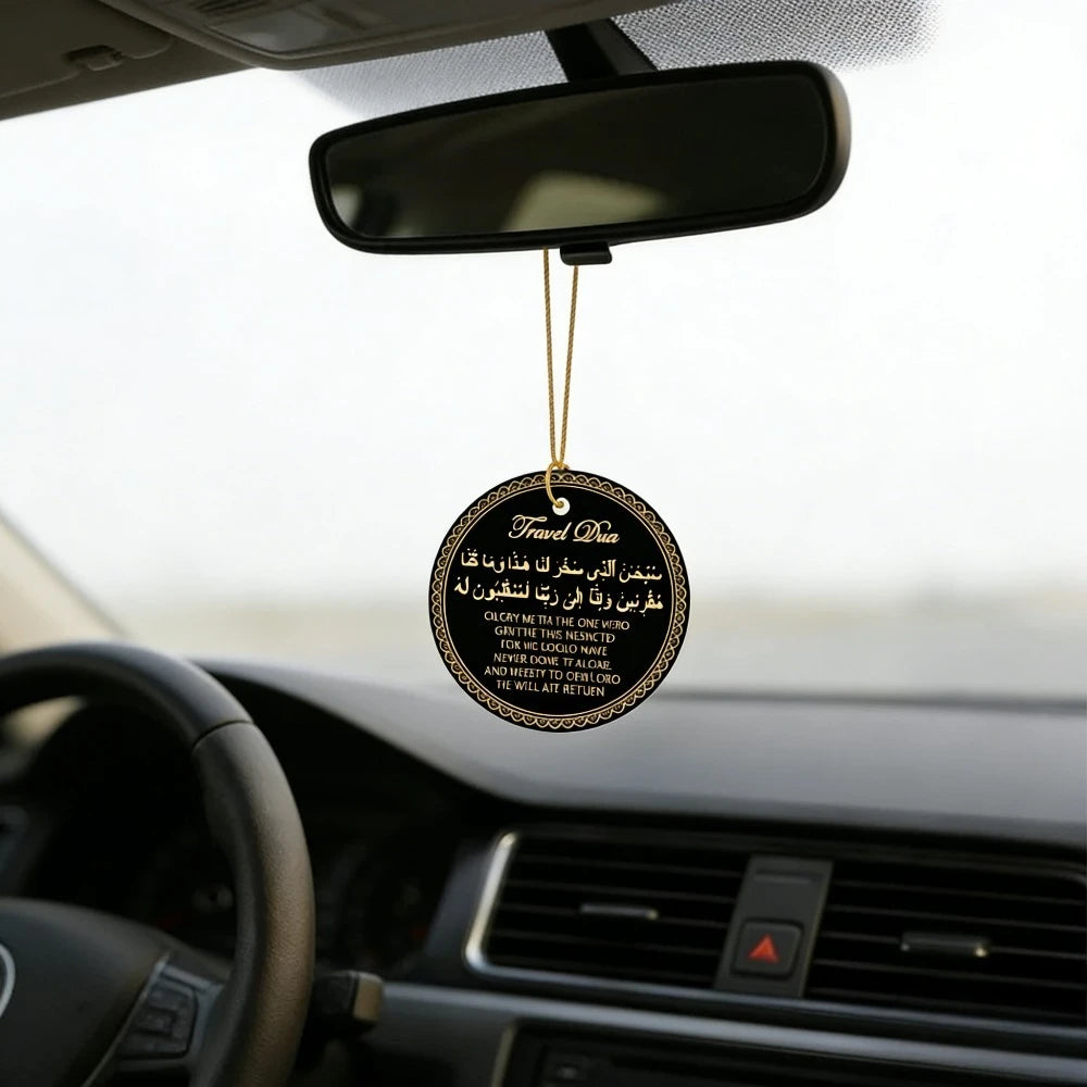 A round leather tag with gold lettering hangs from a rearview mirror on a car windshield.