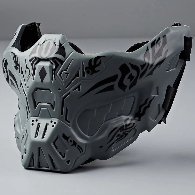 A tactical silicone half-face mask in gray with intricate tribal patterns, shown from the front.