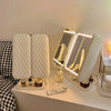 A tri-fold LED makeup mirror with dimmable lighting displayed on a white surface.