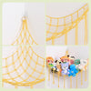 Yellow cotton mesh toy hammock for stuffed animals and plushies hanging on a wall