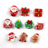 Un juego de lindos imanes navideños que incluye a Santa, una caja de regalo roja, un árbol de Navidad, una corona y figuras d