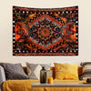 Bohemian sun and moon tapestry wall hanging featuring intricate orange, black, and gold patterns.