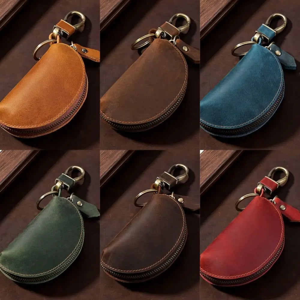 A set of four Crazy Horse leather key pouches in brown, teal, olive green, and red, each with a carabiner clip.