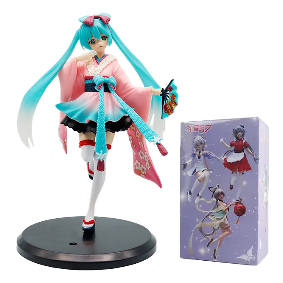 A PVC collectible figurine of Hatsune Miku in a pink and teal outfit with long blue hair.