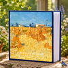 A blue photo album titled Cherished Moments featuring a yellow field of golden wheat under natural light.