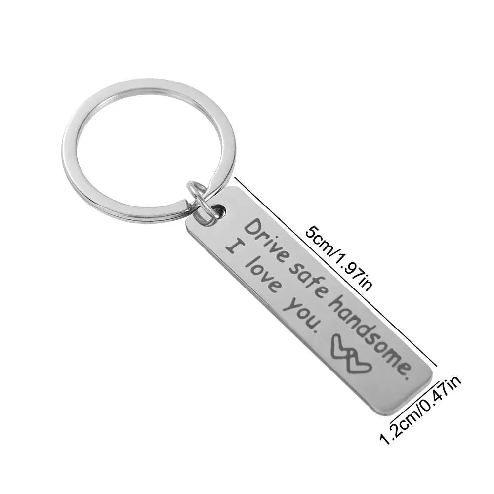 Silver stainless steel keychain engraved with the message Drive safe I love you handsome.