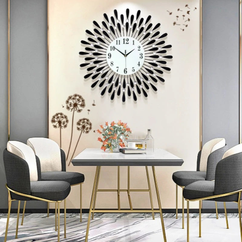 A modern minimalist metal wall clock with a black face is displayed on a light-colored wall.