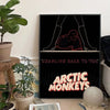 A black canvas art print featuring a silhouette of hands and the text CRAWLING BACK TO YOU and ARCTIC MONKEYS in orange font.