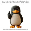 A black and white penguin desk statue with one flipper raised.