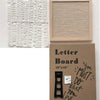 A pink felt letter board featuring white letters and a wooden stand.