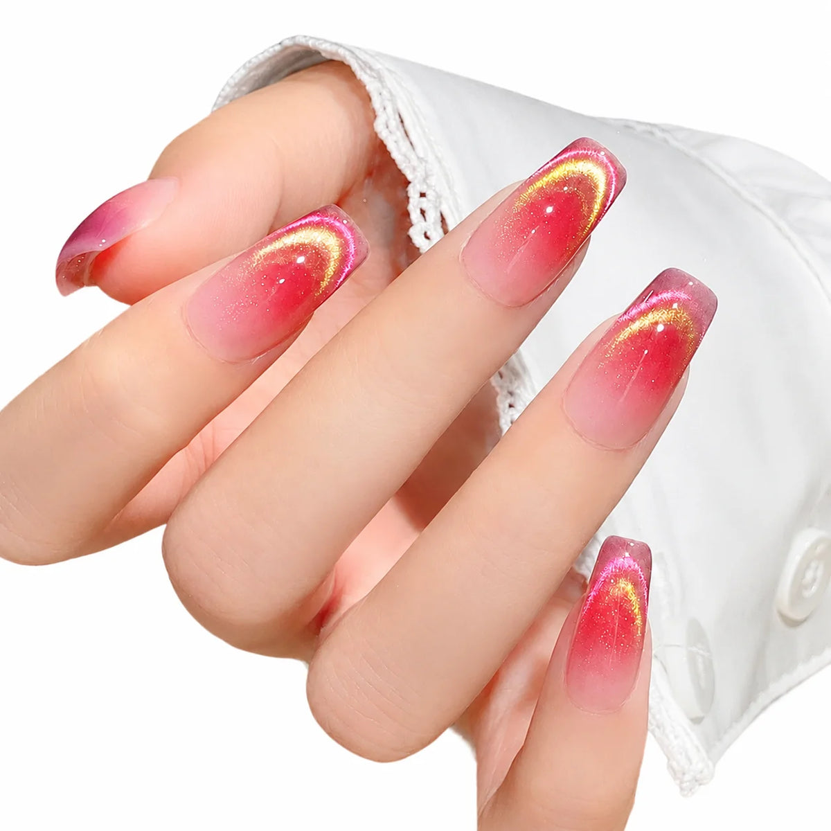 A hand displays a nail with a gradient pink to red magnetic gel polish finish.