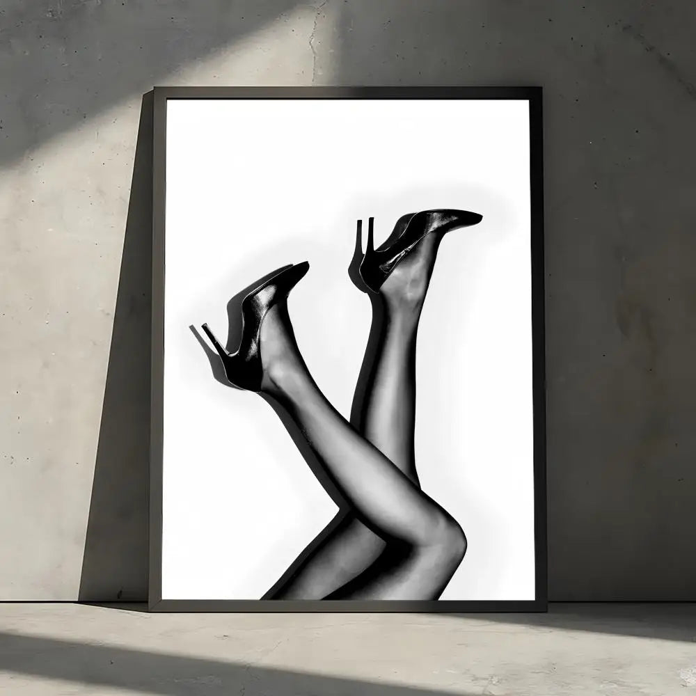 A black and white portrait of a woman's legs and feet, captured in a high-fashion style.
