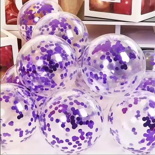 A close-up view of a pile of translucent purple and pink latex balloons filled with confetti.