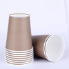 A set of elegant solid color disposable tableware cups in matte brown and white.