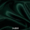 Dark emerald green satin fabric draped and folded