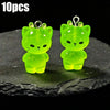 Ten pairs of glow-in-the-dark green cartoon kitty duck resin charms displayed on a dark surface.