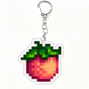 A clear acrylic keychain charm shaped like a strawberry with green leaves and red interior.