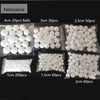 Assortment of white polystyrene foam balls in various sizes and quantities for crafting