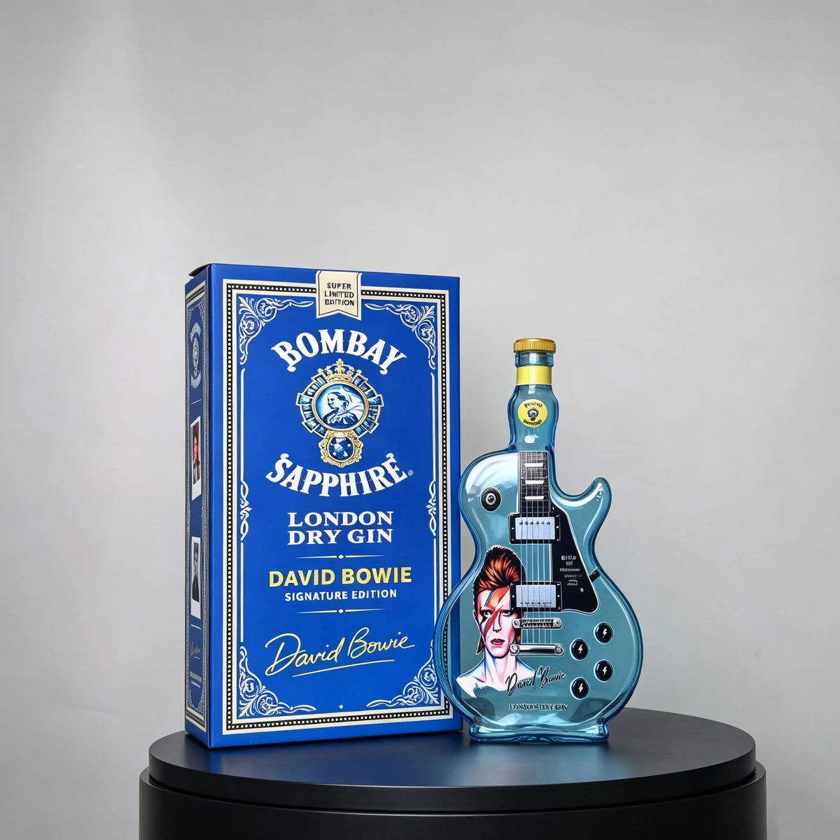 A blue box featuring a guitar-shaped glass decanter of Bombay Sapphire London Dry Gin.