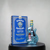 A blue box featuring a guitar-shaped glass decanter of Bombay Sapphire London Dry Gin.