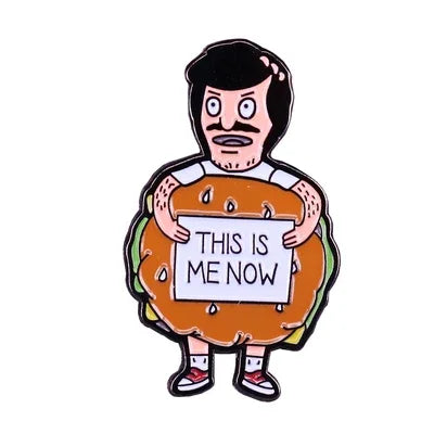 An enamel pin featuring a cartoon man with a surprised expression holding a sign that reads This is me now