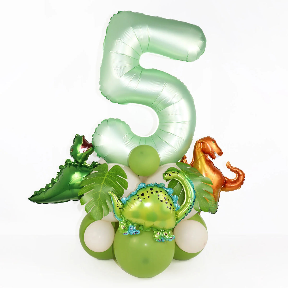 A set of avocado green foil balloons shaped like the number 5 and various dinosaur-themed balloons for a birthday decoration 