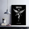 A black poster featuring a silhouette of a winged figure with the text Nirvana in utero.