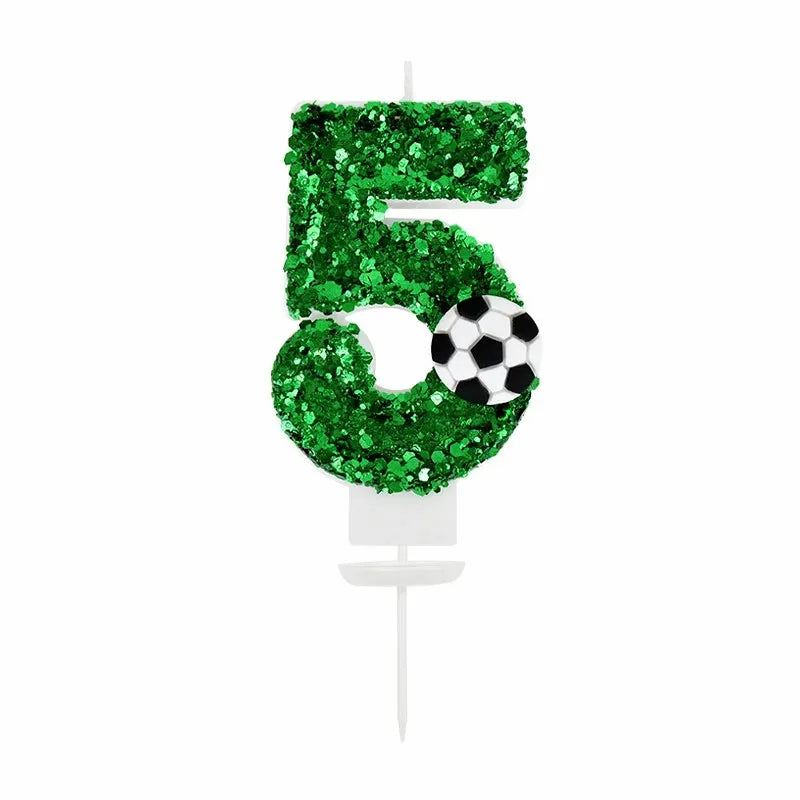 Green glitter number 5 candle with a soccer ball design for a birthday celebration