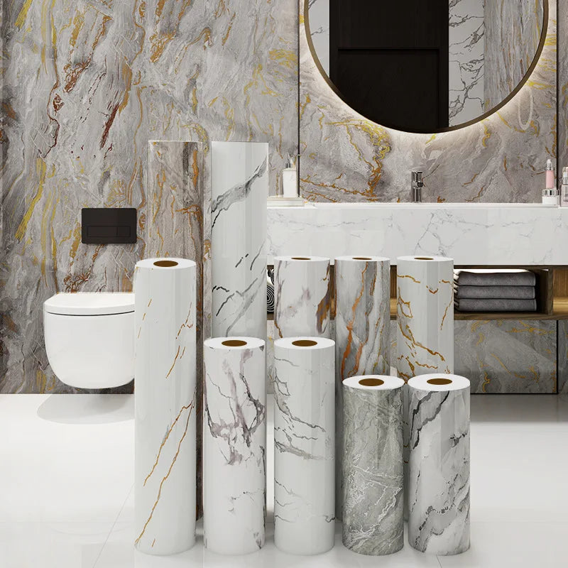 A collection of white marble contact paper rolls displayed in a bathroom setting.