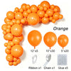 A collection of orange latex balloons and accessories including ribbon, chain, and glue for party decor