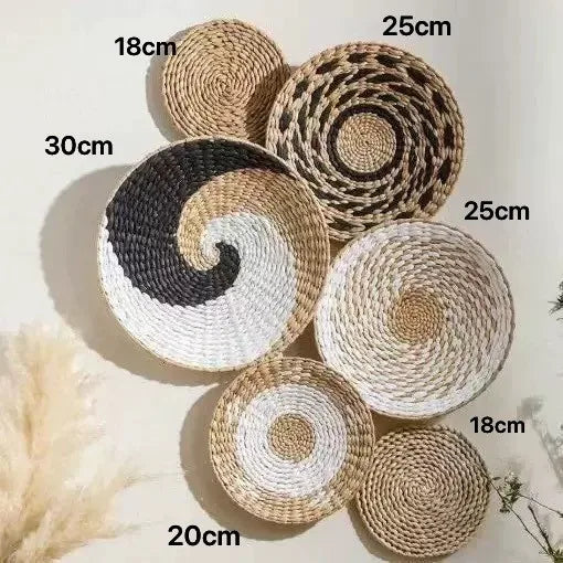 A collection of round woven straw wall hangings in various shades of natural beige and brown.