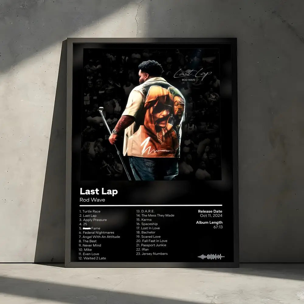 A framed poster featuring the album art and tracklist for Last Lap by Rod Wave, displayed on a gray wall.