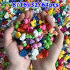 A hand holds a pile of assorted resin miniature figurines in various colors and sizes for DIY decor.
