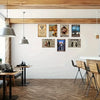 A gallery wall featuring custom aluminum signs with text and imagery mounted on a white wall.