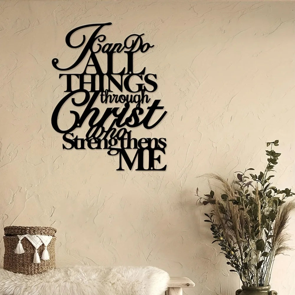 Black script wall art featuring the verse "Fan Do All Things Through Christ That Strengthens Me" on a beige wall.