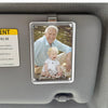 A clear acrylic photo clip featuring a portrait of an elderly man smiling, mounted in a car sun visor.