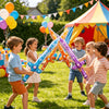 Children playing outdoors with inflatable pirate swords and balloons in a sunny park setting.