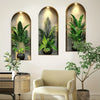 A gallery wall featuring three potted green plants in arched frames on a white wall.