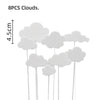 Eight white cloud-shaped cake toppers on sticks for a birthday party decoration